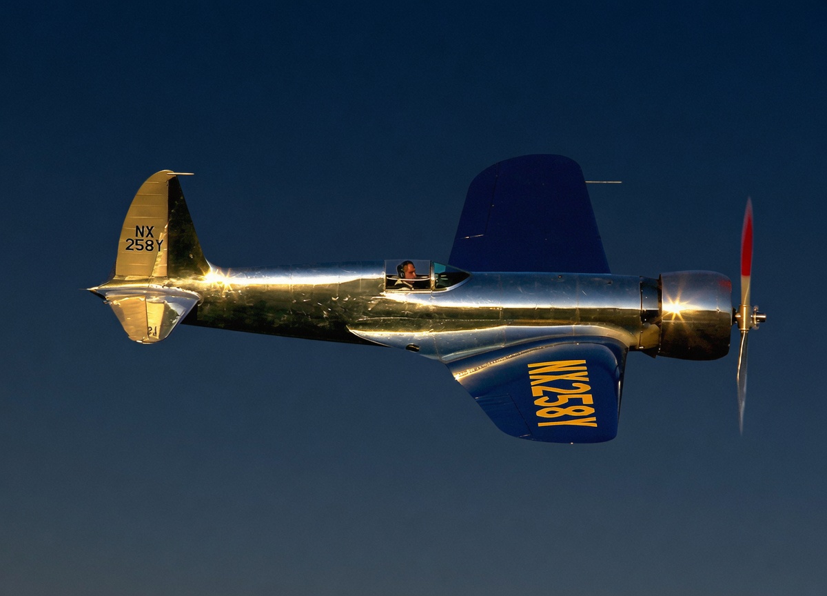Hughes H-1 Racer in polished aluminum against a dusk sky